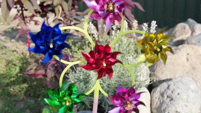 children wind‑up toy with colorful propellers that spin in wind
