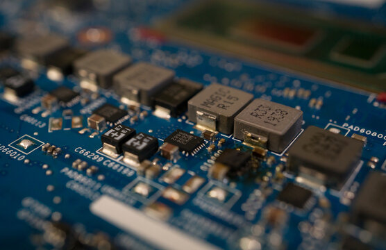 Macro shot of electronic components, microchips and inductors on a computer motherboard 