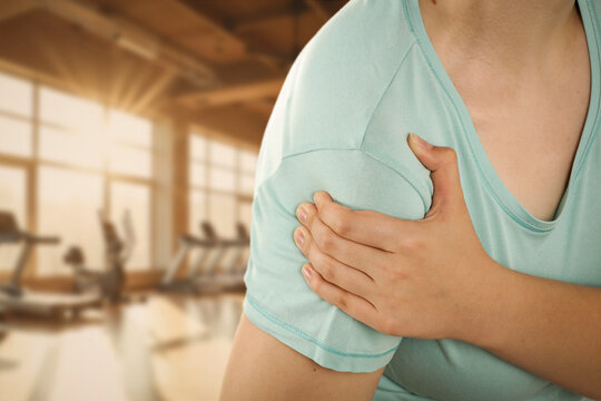Woman stretching and massaging painful body areas of arm&ndash; muscle pain and health concept.