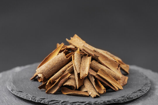 chinese cassia cinnamon bark on a black slate stone tray
