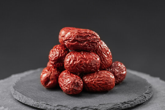 red jujube chinese date or ziziphus on a black slate stone tray