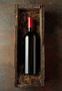 Bottle of red wine in an antique wooden box.