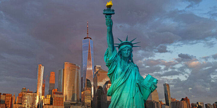 Liberty monument. Liberty statue before New York City skyline. Iconic America symbol. New York City skyline. Famous USA symbol in NYC. Statue of Liberty in New York City.