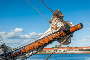 Tall ship bowsprit with furled sail in harbor © Georg