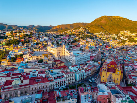 Vista a&eacute;rea panor&aacute;mica de la Universidad de Guanajuato y ciudad colonial colorida en la hora dorada del atardecer en M&eacute;xico