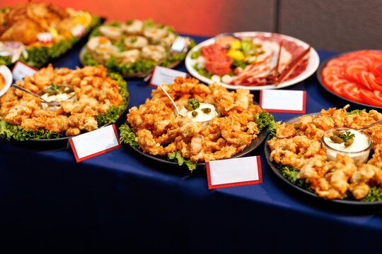 Appetizer buffet table spread with fried snacks and cold cuts