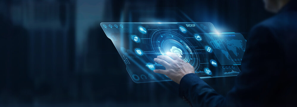 Businessman analyzing Backup and cloud storage recovery data on digital screen. Cybersecurity protection, secure server archive, database redundancy, IT infrastructure resiliency.