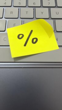 Percentage discount sticky note on laptop keyboard tech sale