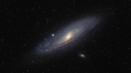 Fototapeta premium The Andromeda Galaxy Messier 31, the nearest large spiral galaxy to the Milky Way, with its bright core, dust lanes and satellite galaxies M32 and M110