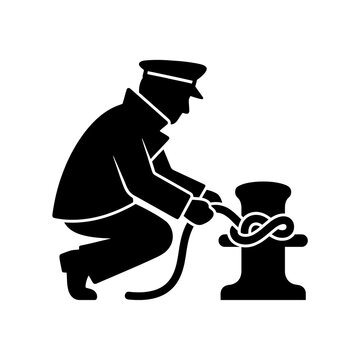 Black silhouette of a sailor tying a rope knot on a boat cleat, securing a vessel at a dock or harbor with precision.