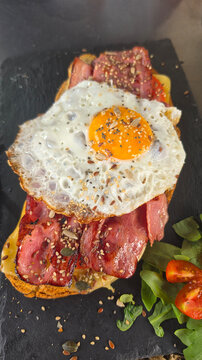 Fried Egg and Bacon Toast with Seeds on Black Slate Serving Board