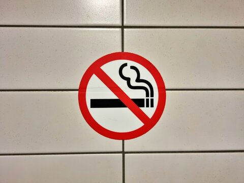 Mainz, Rhineland Palatinate, Germany: No smoking sign displayed on tiled wall indicating smoke free area and smoking prohibition.