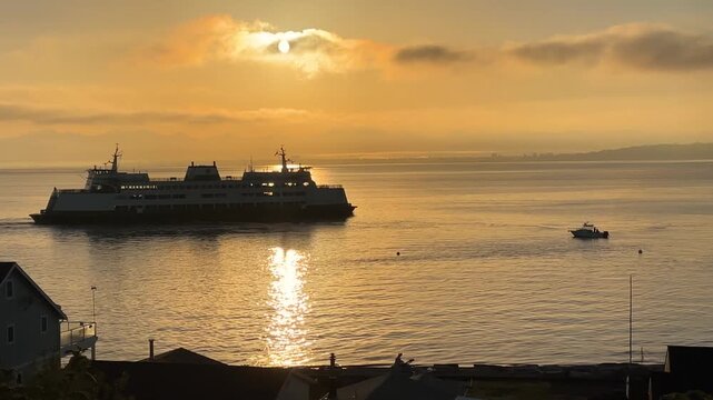Ferry at sea at dawn. Washington state ferry leaving Whidbey Island at sunrise.