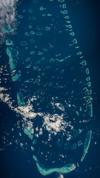 Aerial photo of the Maldives islands  featuring Mandhoo, Fenfushi, Maamigili, Dhigurah, Dhangethi, Mahibadhoo, Kunburudhoo, Omadhoo, and Hangnaameedhoo Islands.