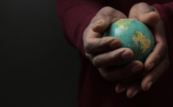 hand holding globe traveling and fighting the coronavirus  pandemic outbreak on black background with people stock photo stock image  