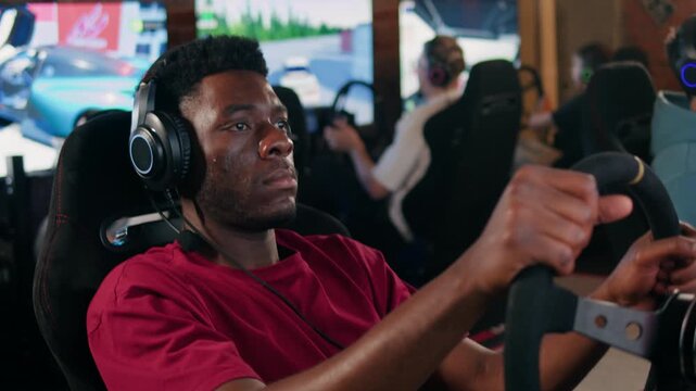 Gamers are playing racing games on a car simulator with a steering wheel background, african american man race drive simulator driving school classes. 