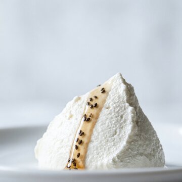 Creamy curd cheese pyramid topped with honey and chia seeds on plate