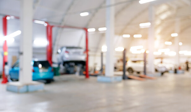 Blurred background fix Cars on lifts and vehicles in spacious auto repair garage