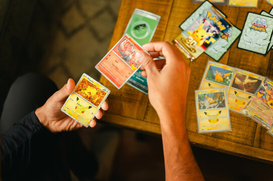 Chicago, IL/USA - September 19, 2026: collector opening Pok&eacute;mon 30th anniversary cards and sorting Pikachu pulls