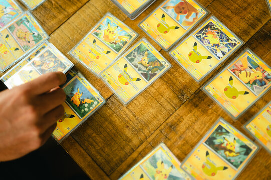 Chicago, IL/USA - September 19, 2026: Person sorting collectible Pikachu cards from the Pok&eacute;mon 30th Celebration set