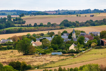 Fototapeta premium Village of Culey-le-Patry, a small village in the Norman bocage near Saint-Rémy-sur-Orne, dominated by the bell tower of the Église de la Nativité-de-Notre-Dame