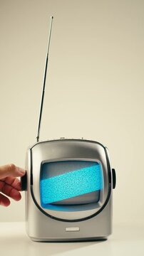 Retro TV, vintage television In a nostalgic setup, a retro TV displays grain on screen, scary halloween night device good for chroma key and green screen.