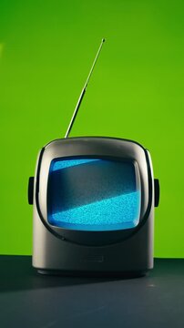 Retro TV, vintage television In a nostalgic setup, a retro TV displays grain on screen, scary halloween night device good for chroma key and green screen.
