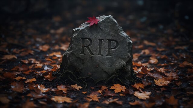 Weathered grey stone tombstone carved with rip letters sits peacefully in dark autumn forest covered with dry orange maple leaves under soft moody natural lighting