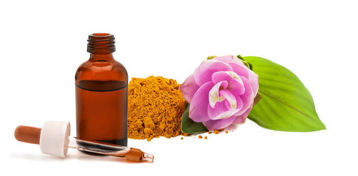 Turmeric powder with turmeric flower, dropper and bottle isolated on white background