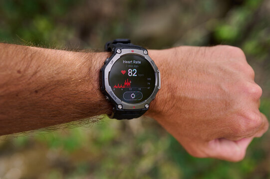 Smartwatch displaying heart rate pulse measurement on a man's wrist