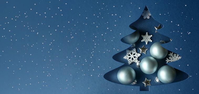 Paper christmas tree with gold star topper and metallic ornaments isolated on a transparent background.