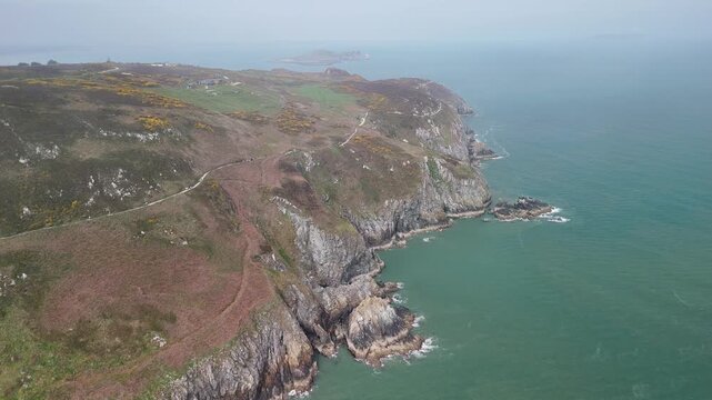 Aerial flight over Howth with distant view of Ireland's Eye in fog