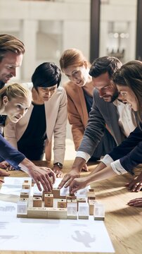 Lifelong learning and leadership training workshop with business team organizing wooden blocks
