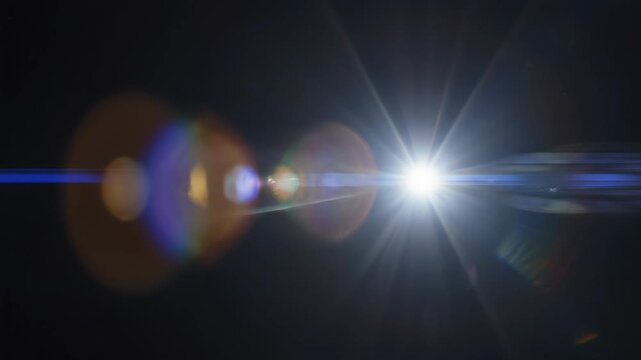Lens flare light streaks emanating from a bright point source during a cinematic zoom out