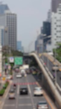 Bokeh view of road traffic in Bangkok, Thailand. Blurred background vertical footage.