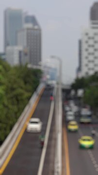 Bokeh view of road traffic in Bangkok, Thailand. Blurred background vertical footage.