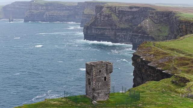 Moher Tower with the Cliffs of Moher behind it, County Clare, Ireland