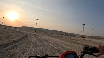 First-Person View from Quad Bike Riding Sandy Desert Track at Golden Sunset in Qatar © Kaitlind
