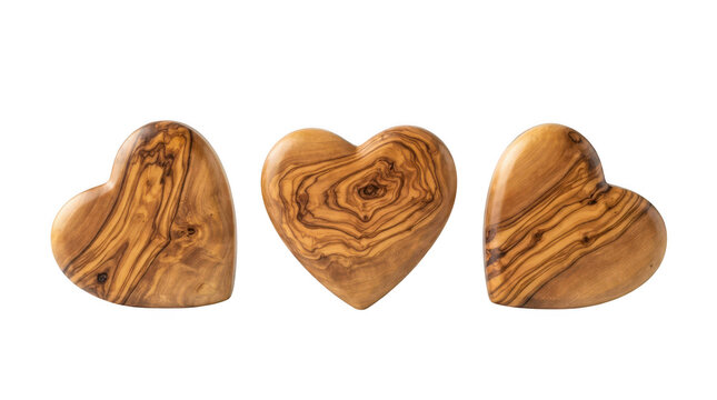 Three decorative heartshaped ornaments carved from natural olive wood with beautiful grain patterns, isolated on transparent background