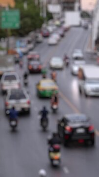Bokeh view of road traffic in Bangkok, Thailand. Blurred background vertical footage.