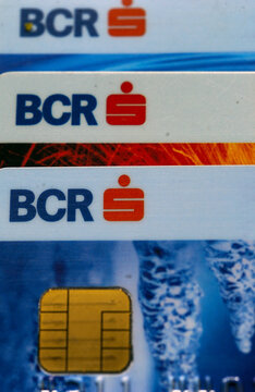 Bucharest, Romania - May 24, 2023: Close-up macro view of stacked BCR Erste Group plastic banking credit and debit payment cards showing gold microchip.