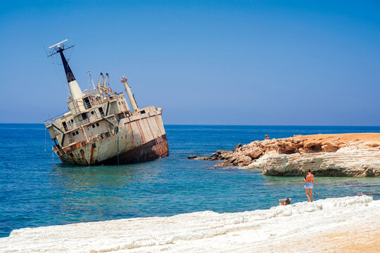 Rustic shipwreck on serene beach near Peyia village. Cyprus