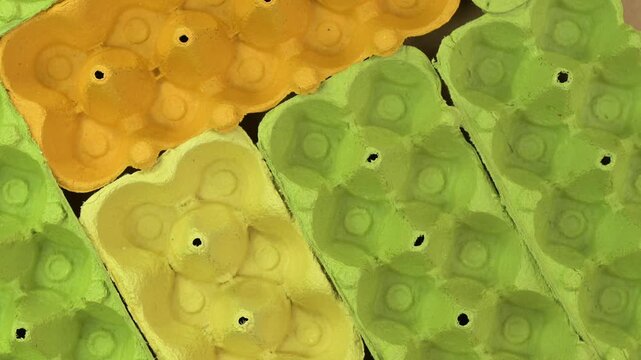 Empty egg cartons or egg packaging in different colors ready for recycling 
