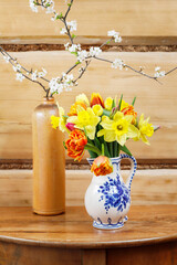 Spring postcard motifs with tulips, daffodils, roses and blooming branches of fruit trees. © agneskantaruk