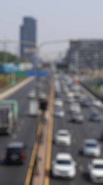 Bokeh view of road traffic in Lumphini district, Bangkok, Thailand. Blurred background vertical footage.