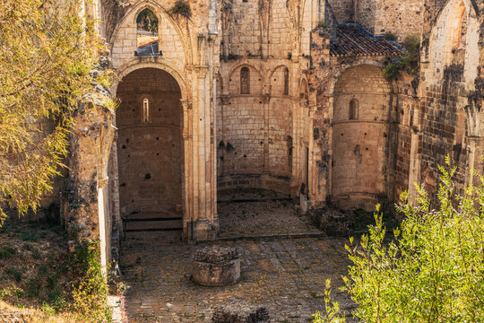 Gothic monastery ruins interior with stone arches and apse