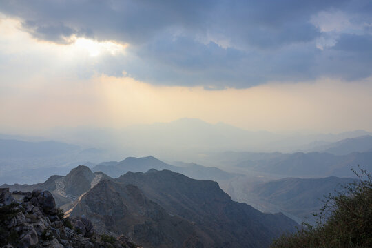 Saudi Arabia Tourism - Dramatic sunbeams breaking through clouds over Al Hada mountain in Al Taif, - Saudi National Day and travel 