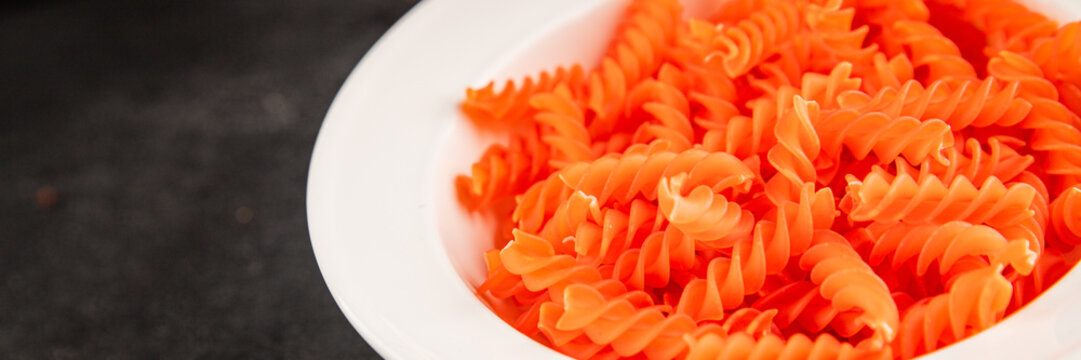 Red lentil pasta fusilli gluten-free fresh pasta healthy eating tasty snack gourmet, rustic food background on the table top view copy space  vegetarian and vegan food
