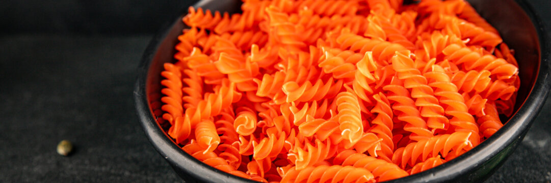 Red lentil pasta fusilli gluten-free fresh pasta healthy eating tasty snack gourmet, rustic food background on the table top view copy space  vegetarian and vegan food