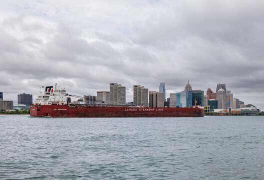 Canada Steamship Lines freighter transits Detroit River near Detroit skyline, illustrating cross-border shipping routes and trade tariff disputes. July 2026